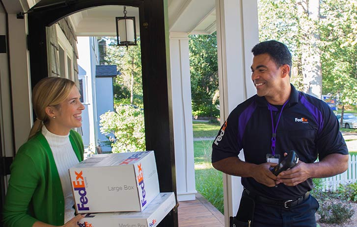 Woman receiving package delivery at home